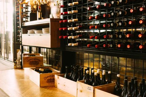 a room with a bunch of wine bottles in boxes at Paradox Sydney in Sydney