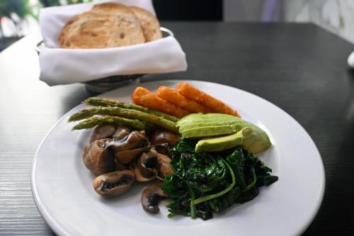 a plate of food with vegetables and bread on a table at Paradox Sydney in Sydney