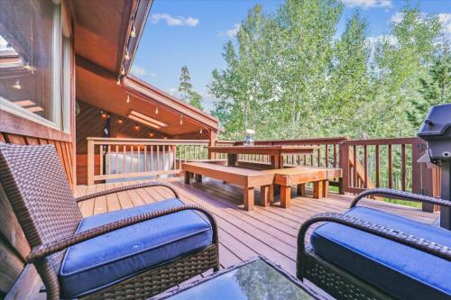 a deck with two chairs and a table and a bench at Twins Getaway at Meadow Creek Duplex in Frisco