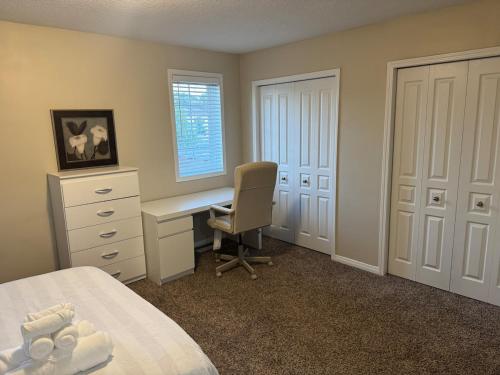 a bedroom with a desk and a bed and a chair at Charming 3bedroom 3bath house in Kitchener