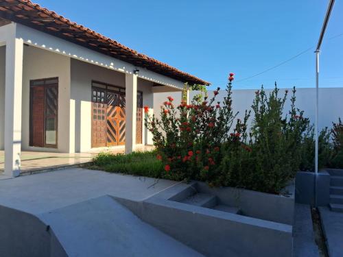 a house with some flowers in front of it at Casa com piscina in Juazeiro do Norte