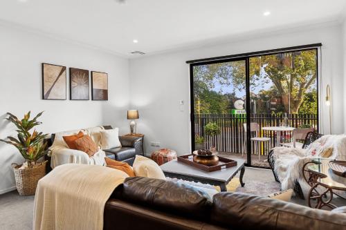 a living room with a couch and a table at Flash Stay Deal! Masterpiece Modern 3beds in Hamilton