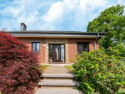 a brick house with a pathway leading to it at Charming cottage in heart of the Ardennes in Lierneux