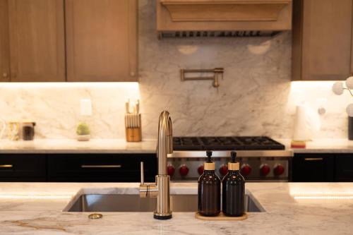 a kitchen with a sink and two bottles of wine at NEW! LUX 4BR + Rooftop | Parking | Metro in Washington, D.C.