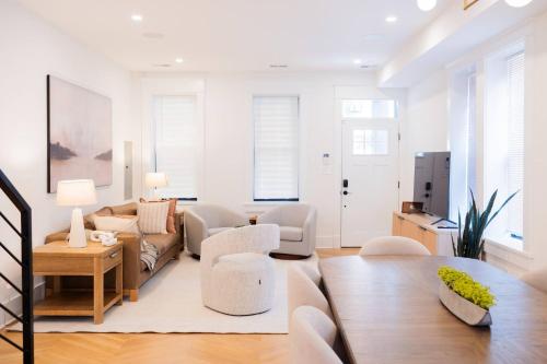 a living room with a couch and a table at NEW! LUX 4BR + Rooftop | Parking | Metro in Washington, D.C.