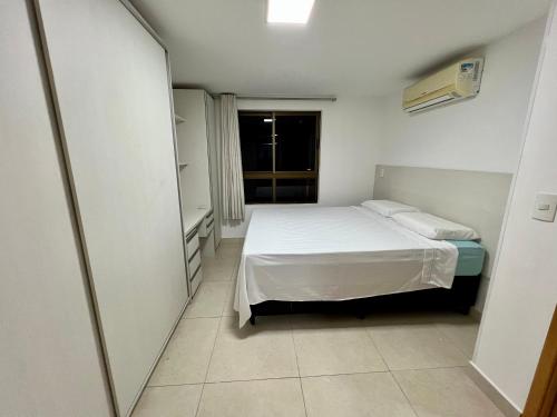 a small room with a bed and a window at Luxor Paulo Miranda in João Pessoa