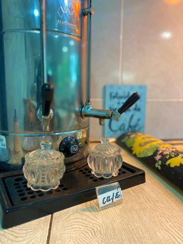 a stove top with two glass dishes on it at Pousada Costa Tropical in Tamandaré