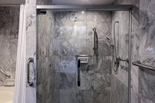 a shower with a glass door in a bathroom at Kosa Hotel & Wellness Center in Khon Kaen