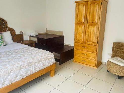 a bedroom with a bed and a dresser and a desk at Hotel La Lejona in San Miguel de Allende