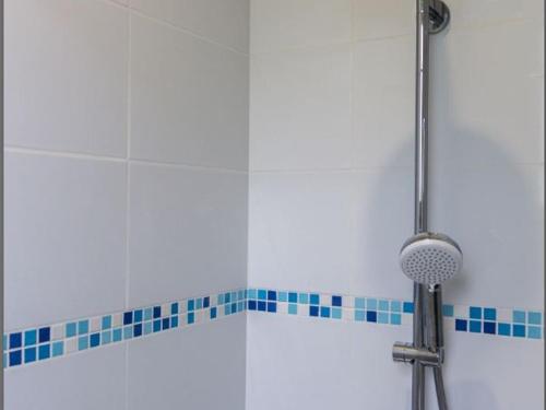 a shower in a bathroom with blue tile at Gîte familial en Auvergne avec jardin, ping-pong, proche stations thermales, animaux acceptés - FR-1-489-127 in Mazirat