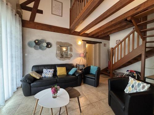 a living room with a couch and a table at Fermette rénovée avec jardin clos, animaux acceptés, WiFi et parking - FR-1-489-87 in Bourbon-lʼArchambault