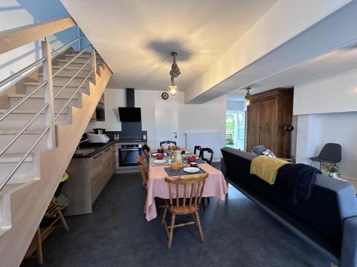 Il comprend un salon avec une table à manger et une cuisine. dans l'établissement Gîte Champêtre avec Animaux, Spa et Tout Confort en Pleine Nature Bourbonnaise - FR-1-489-539, à Buxières-les-Mines