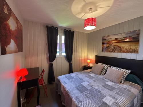 a bedroom with a bed and a red lamp at Gîtes proches vignoble, déco cosy, terrasse, activités familiales et nature - Tout inclus - FR-1-489-235 in Meillard