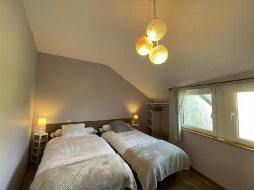 a bedroom with two beds and two lights at Gîte Contemporain Confortable à Louchy-Montfand avec Piscine Partagée - FR-1-489-444 in Louchy-Montfand
