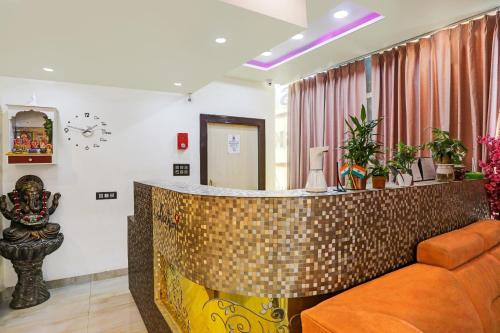 a bar in a living room with a couch at Hotel O S.N Sky Awadh in Lucknow