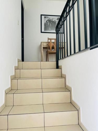 a staircase in a home with white walls at Hotel La Lejona in San Miguel de Allende