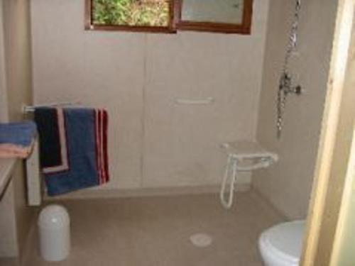 a bathroom with a tub and a toilet and a sink at Chalet accessible PMR avec terrasse et animaux acceptés - FR-1-496-243 in Saint-Rirand