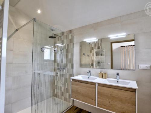 a bathroom with a sink and a shower at Gîte de charme avec spa, terrasse et balcon - Tout confort, au cœur de la nature - FR-1-496-303 in Pouilly-les-Feurs