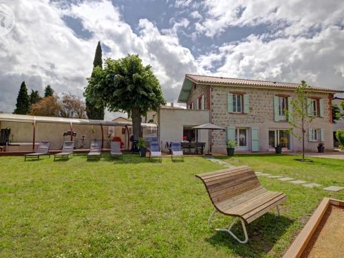 a group of chairs sitting in the yard of a house at Gîte de charme avec spa, sauna et jardin privatif à Montbrison - FR-1-496-309 in Montbrison