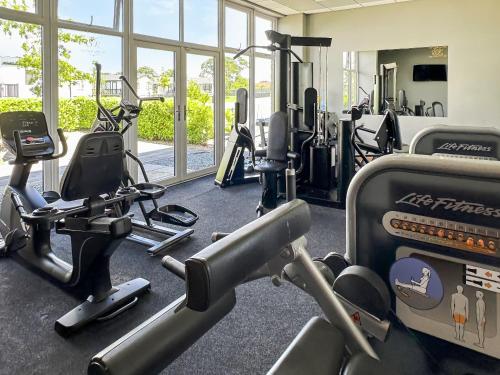 a gym with several treadmills and machines in a room at Lodge 78 in St. Andrews