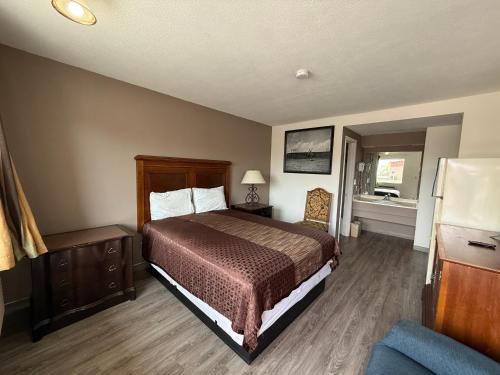 a hotel room with a bed and a window at Island Inn in Grand Island