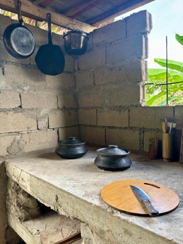 a counter with four pots and pans on it at El Trinidad Organic Farm in El Nido