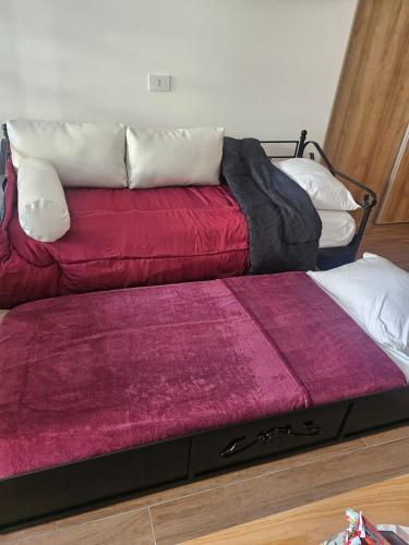 a couch sitting on top of a bed in a room at Cómodo y moderno departamento en Buenos Aires in Buenos Aires