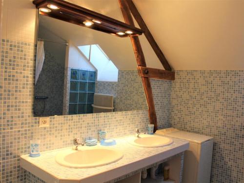 a bathroom with two sinks and a mirror at Maison de campagne avec wifi près de Thenon, 3 chambres - FR-1-616-138 in Azerat