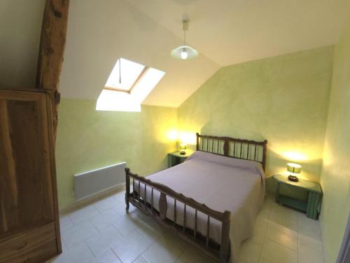 a bedroom with a bed and a skylight at Maison de campagne avec wifi près de Thenon, 3 chambres - FR-1-616-138 in Azerat