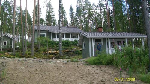 a house in the middle of a forest at Lake Cottage Jänisvaara in Kolinkylä