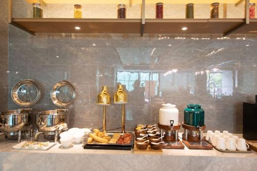a kitchen counter with some food on a table at Atour X Hotel Shenzhen Bao'an Airport West Bay Mangrove in Bao'an