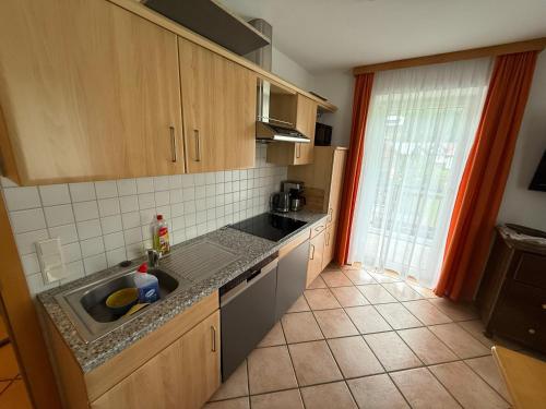a kitchen with a sink and a counter top at Appartement Millennium in Bad Gastein