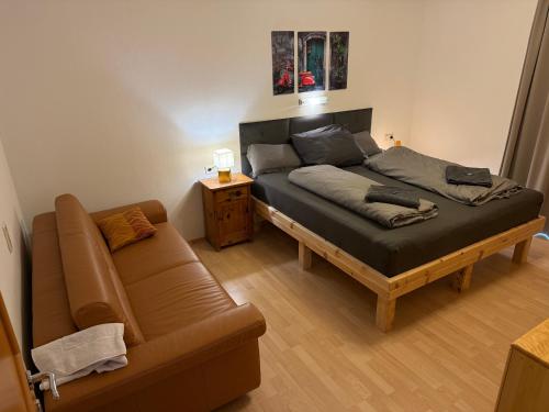 a bedroom with a bed and a couch at Appartement Millennium in Bad Gastein