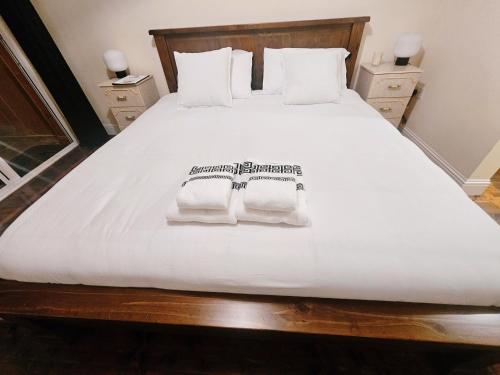 a large white bed with two towels on it at Listowel Town in Listowel