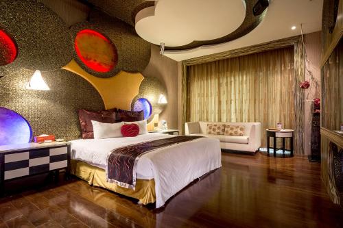 a bedroom with a large bed and a couch at Norway Forest SPA Motel in Xindian