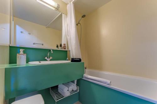a bathroom with a sink and a mirror at Modern 3BR Duplex - Val Thorens Centre, Parking & Panoramic Views in Val Thorens