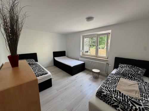 a room with two beds and a couch and a window at WatzMannEG in Augsburg