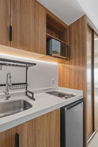 a kitchen with a sink and a microwave at Studio Ala Kai in Puerto Vallarta