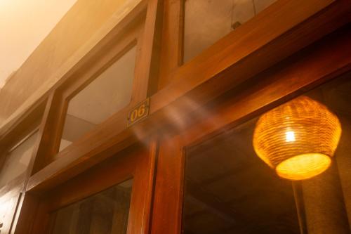 a glass door with a light on top of it at Mich's Surf Villa & Hostel in Weligama