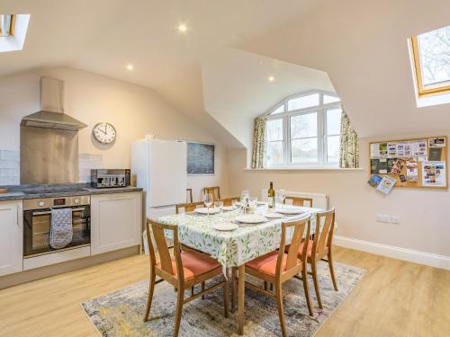 a kitchen and dining room with a table and chairs at The Stables At Wells-In-The-Field Farm in Whitchurch