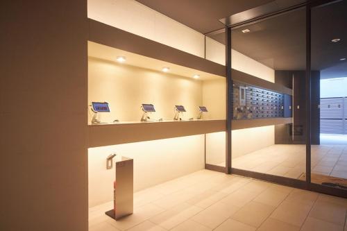 a bathroom with sinks on the wall in a building at BON Condominium Umeda in Osaka