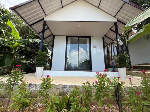 a house with a window and flowers in front of it at SODANY RESORT Kohrong in Koh Rong