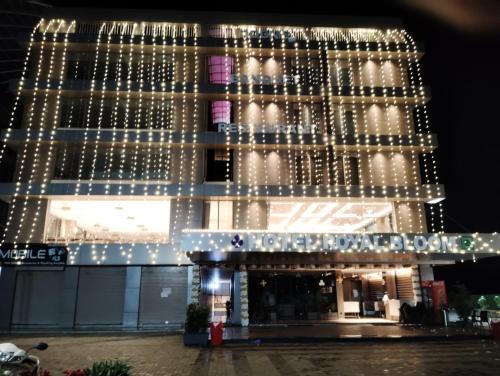 a building with christmas lights on it at Hotel Royal Bloom in Surat