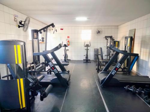 a gym with several tread machines in a room at Apartamento completo em Pinda in Pindamonhangaba