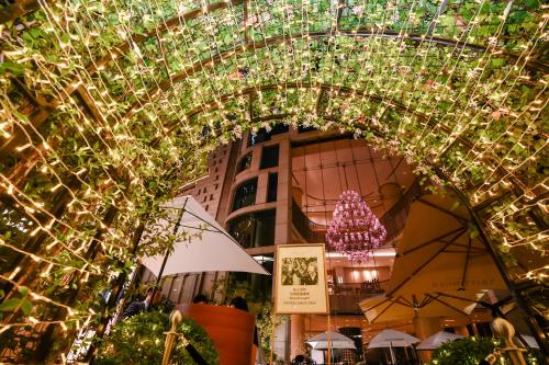 an archway with christmas lights in front of a building at The Langham, Shanghai, Xintiandi in Shanghai