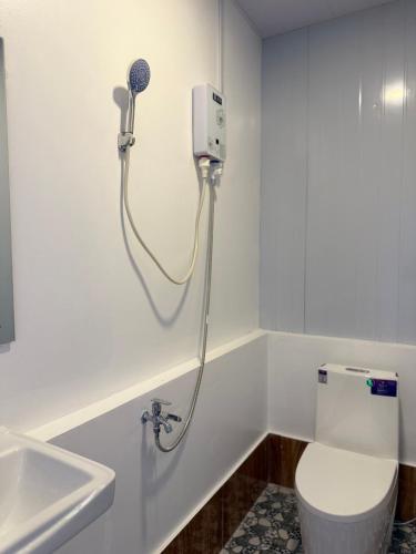 a bathroom with a toilet and a hair dryer on the wall at SODANY RESORT Kohrong in Koh Rong