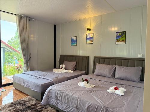 two beds with swans on them in a bedroom at SODANY RESORT Kohrong in Koh Rong