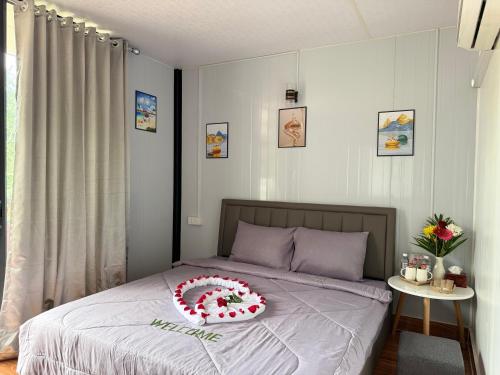 a bed with a red and white cake on it at SODANY RESORT Kohrong in Koh Rong