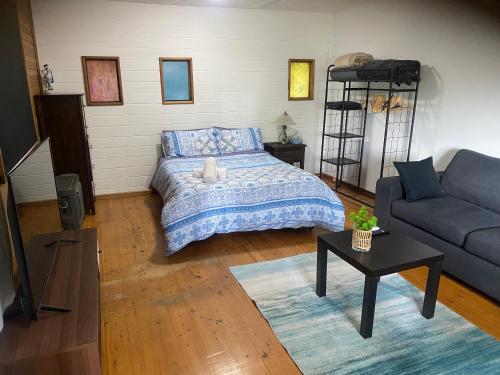 a bedroom with a bed and a couch at Secret Bay Hideaway in Fishing Point
