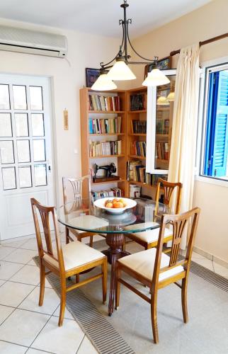 a dining room with a glass table and chairs at Villa Marika in Vathi, Ithaka